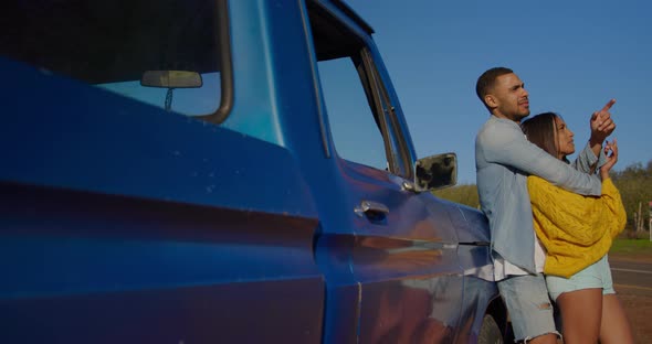 Young couple on a road trip in their pick-up truck