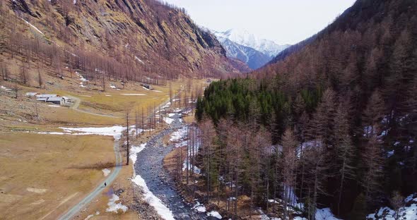 Aerial Flying Moving Forward on River Creek in Yellow Mountain Valley and Forest Woods Fall