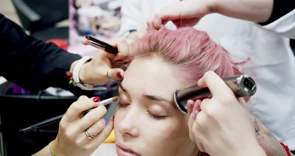 Closeup Set of Many Hands Do the Woman Makeup and Haircut at the Same Time