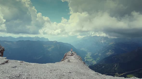 Flying Over Woman Raising Hands on the Top of Piz Boe Mountain in Dolomites