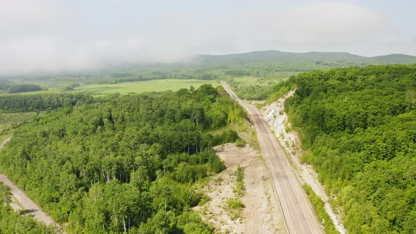 Aerial View of a Black Car Driving on a Country Road