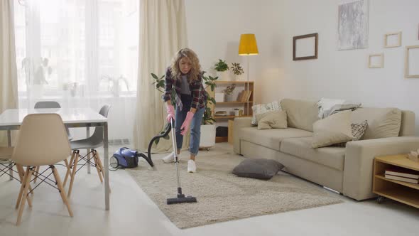 Young Woman Vacuuming at Home