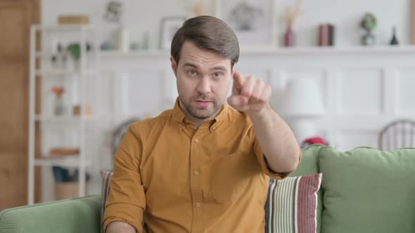 Portrait of Young Man Pointing towards Camera