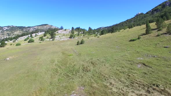 Flying above grass plains of Dinara mountain, Croatia