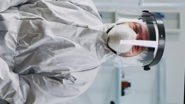 Vertical Video Portrait of Experienced Scientist Man in Coverall Smiling at Camera