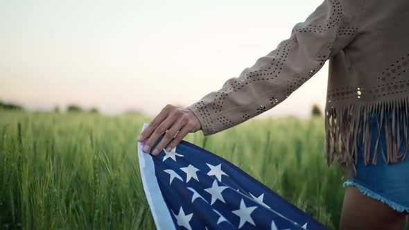 Closeup Rear View Womans Hand with USA National Flag Over Ears of Wheat