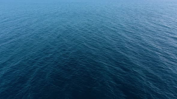 Flying Over the Blue Surface of the Sea or Ocean