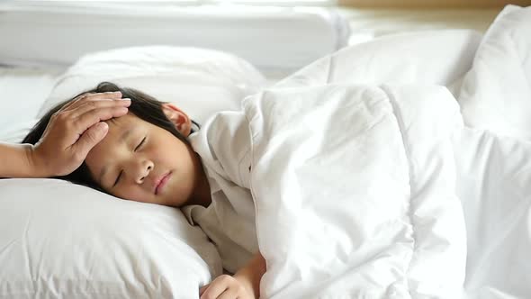 Cute Asian Child Sleeping On White Bed With Mother Care