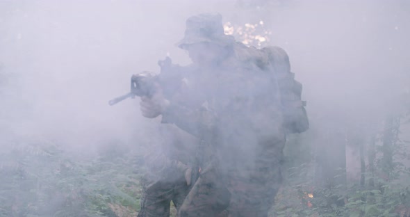Soldiers Taking Aim From Rifle in Forest Smoke in Background Military and Army Concept