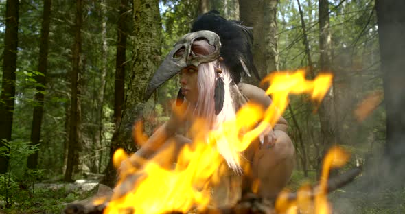 Bright Orange Bonfire Against Mystic Lady with Mask on Head