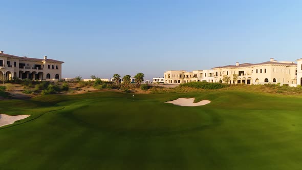 Aerial view of green golf club on a luxury residential area, Dubai, U.A.E.