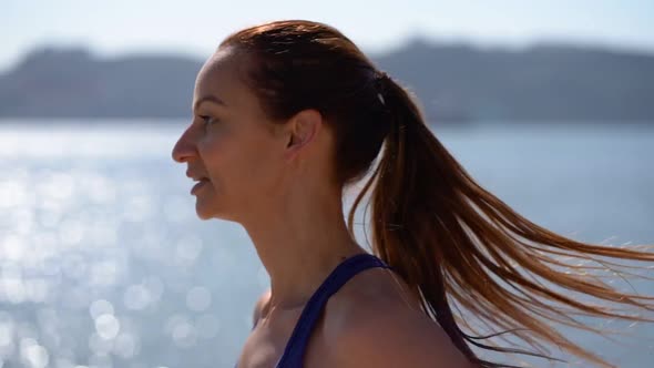 Smiling Sporty Girl Running at Riverside