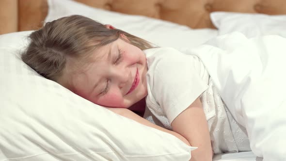 Cute Little Girl Going To Sleep in Her Bed, Mother Tucking the Blanket