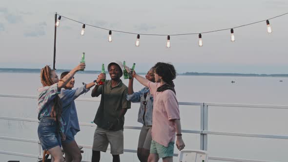 Friends Dancing and Drinking by Lake