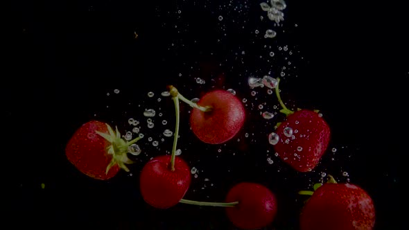 Strawberry and Cherry Slow Motion Closeup Falling in Water