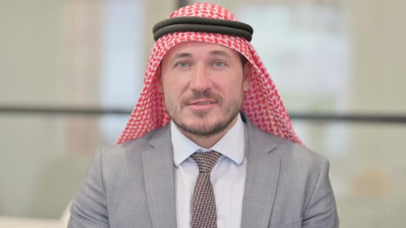 Portrait of Middle Aged Arab Businessman Talking on Online Video Call
