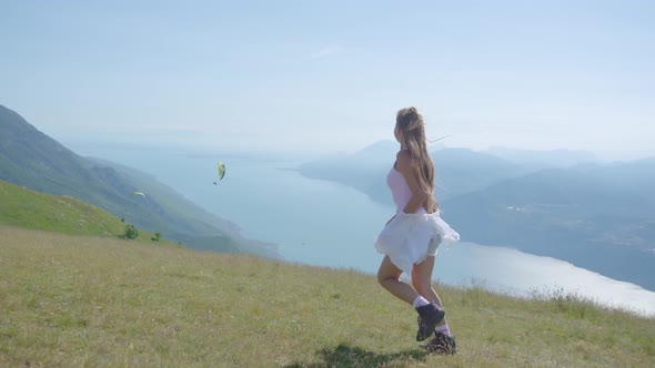 Young Girl Runs Over the Mountains at Lake Garda