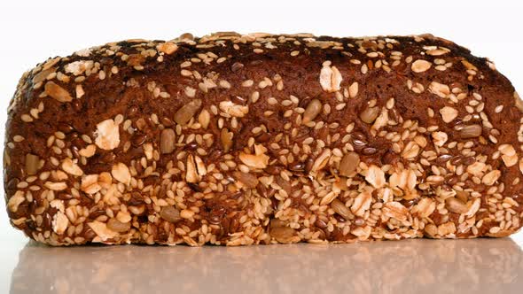 Whole Wheat Bread With Oatmeal Powder Spinning On A White Background