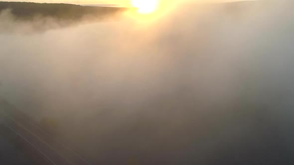 Flying Through the Clouds in Morning Sun Lights, Finnish Landscape with River and Forest, Aerial