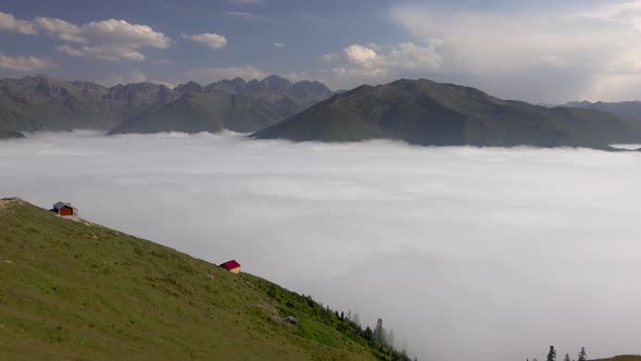 Highland Houses on the Mountain Ridge and Looking the Valley Above the Clouds