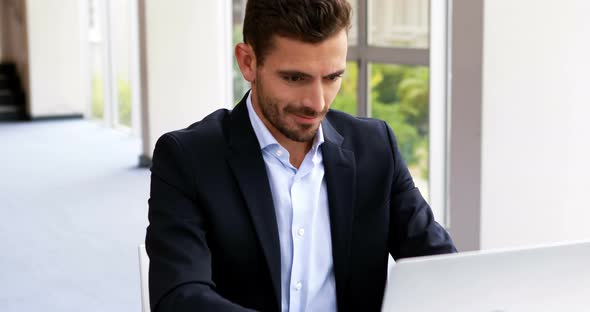 Businessman working on laptop at desk 4k