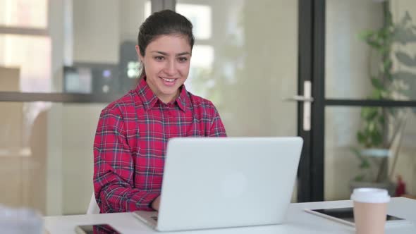 Indian Woman Celebrating While Using Laptop on Bench