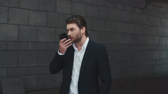 Business Man Arguing in Smartphone at Street. Businessman Typing on Cellphone