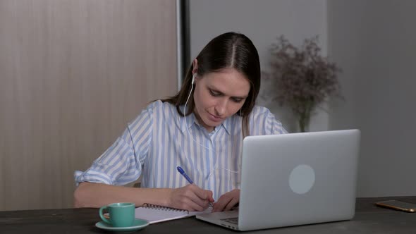 Young Female Student in Headphones Studying at Home Online Education