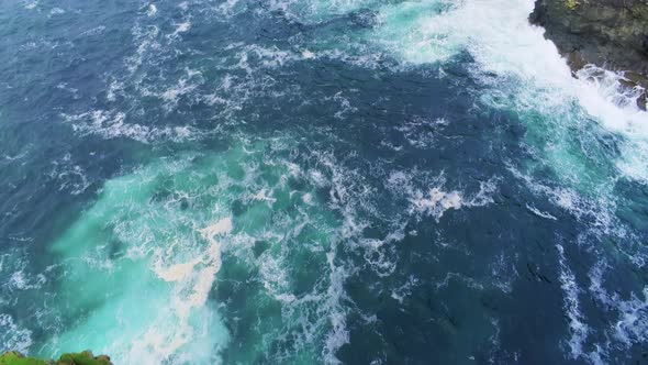 Flight From Steep Cliffs Over Blue Ocean Water