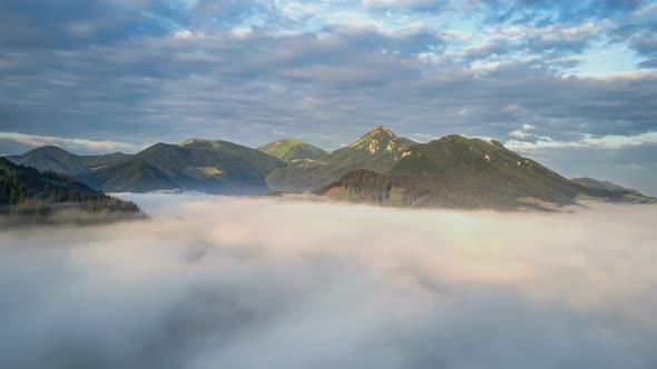 Aerial View above Clouds in Morning Mountains