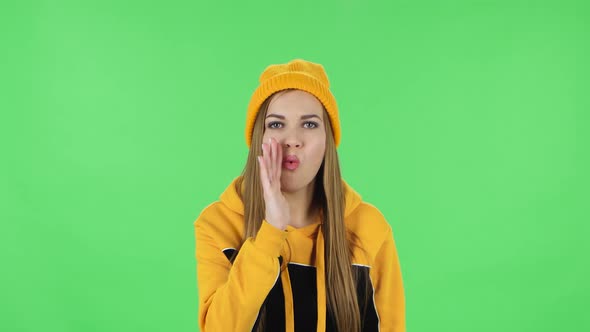 Portrait of Modern Girl in Yellow Hat Is Screaming Calling Someone