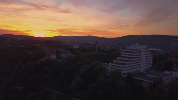 Sunset Red Skyline at Cluj, Romania, Transylvania. Aerial drone over European valley town city with