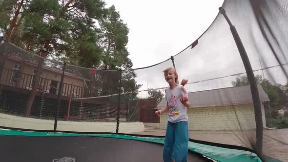 Smiling Girl On A Trampoline