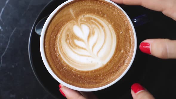 Closeup Of Woman Hands With Coffee Cup In Cafe