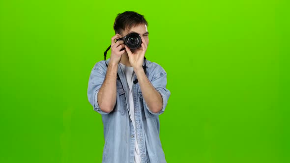 Man Takes Pictures of the Landscapes on the Professional Camera. Green Screen
