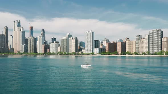 Aerial Sailing Boat in Michigan Lake with Downtown Chicago on Motion Background