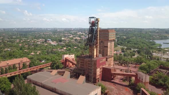 Iron ore mining in the city center. Red mine in the city.