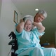 elderly woman with psychiatric symptoms is in a wheelchair with an elderly couple caring for her wit - VideoHive Item for Sale