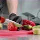 Chef is cutting tomato for burger, hands in black gloves closeup. - VideoHive Item for Sale
