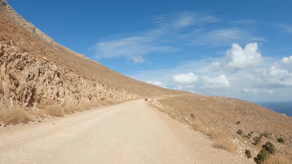 Car POV driving on a ground trail off road. Yellow sandstone, dirt sand trails