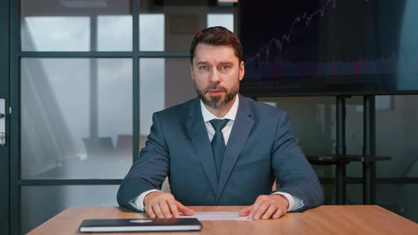 Mature man at video conference. Mature businessman looking at camera consult client from computer