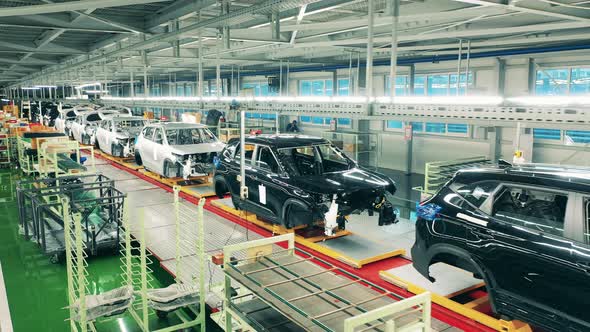 Automobile, Car Factory Conveyor. Factory Premises with Multiple Unfinished Automobiles