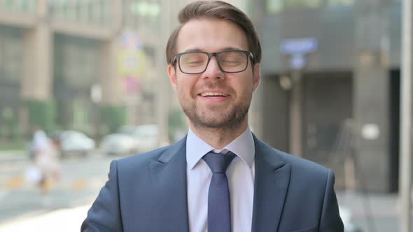 Portrait of Businessman Talking on Online Video Call, Standing in Street