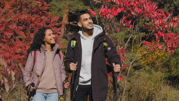 Closeup Young Hikers Travel with Backpacks Do Nordic Walking Talking Enjoy Colorful Natural Scenery