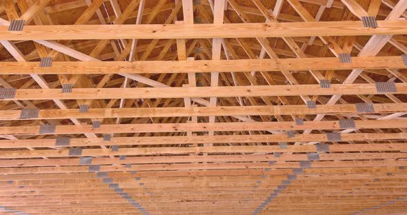 An Underconstruction Residential Building's Roof Post Beam Framework Shows Roofing Trusses
