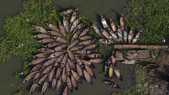 Aerial descends to an array of traditional Ghat wooden boats - Bangladesh