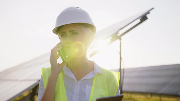 Female Engineer Holding Tablet in Her Hand and Talking on Phone