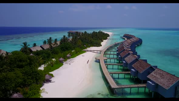 Aerial flying over landscape of beautiful resort beach time by shallow ocean and white sandy backgro