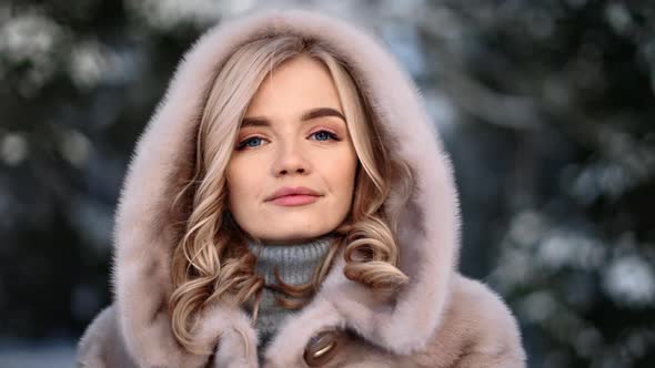 Pleasant Fashion Woman Posing in Fur Coat at Winter Landscape