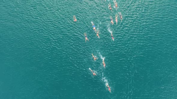 Aerial view of a group swimming at ocean water during competition, Croatia.